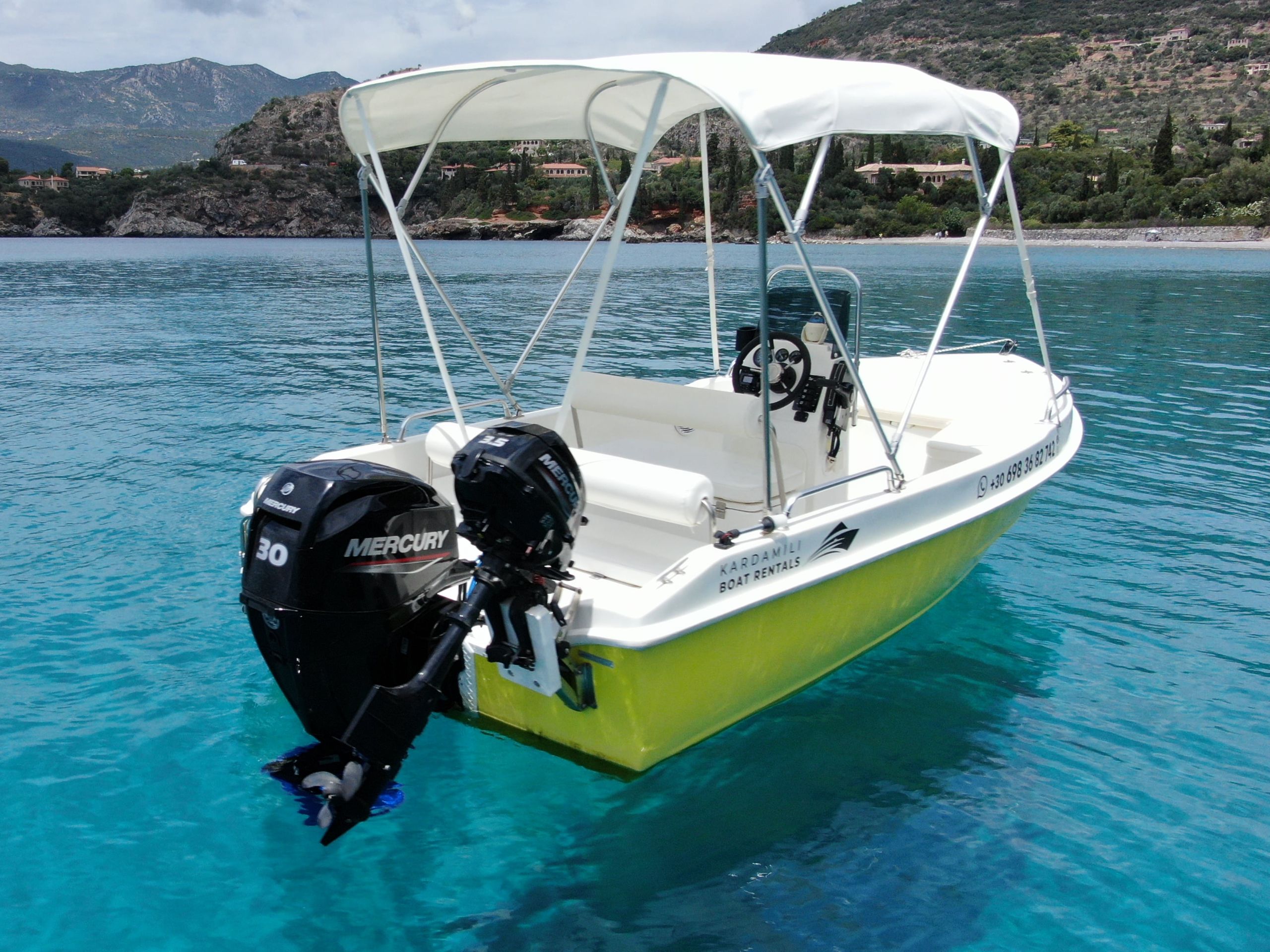 This is an image of our Kardamili Boat Rentals Ritsa boat in sea, in Mani. The boat is yellow and new.