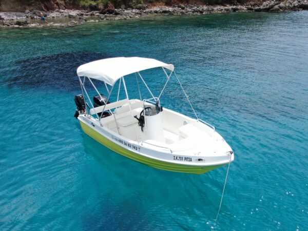 This is an image of our Kardamili Boat Rentals Ritsa boat in sea, in Mani. The boat is yellow and new.